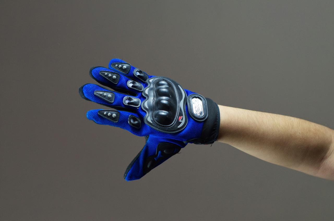 person wearing blue and black gloves